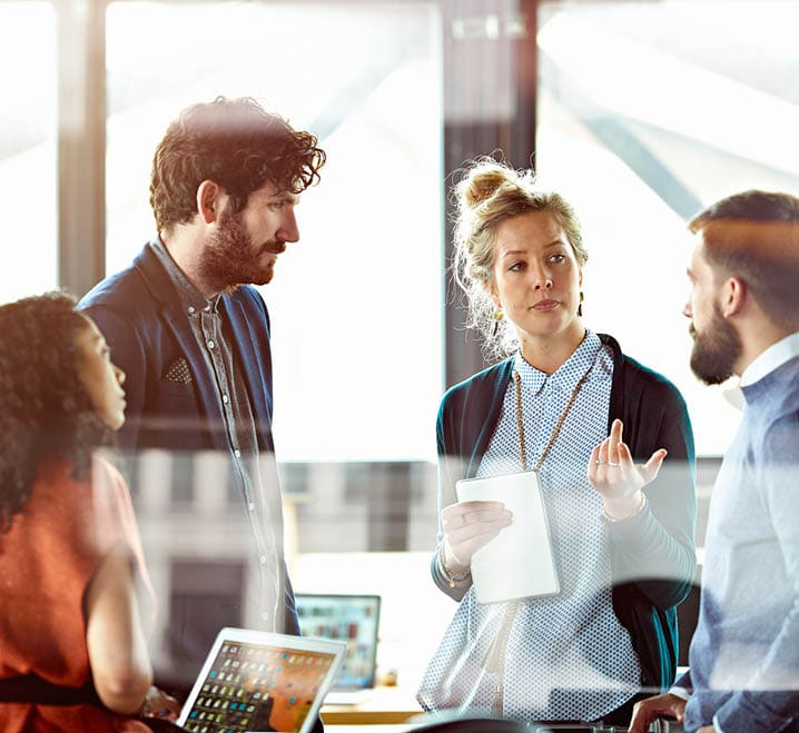 Men and women talking in modern office