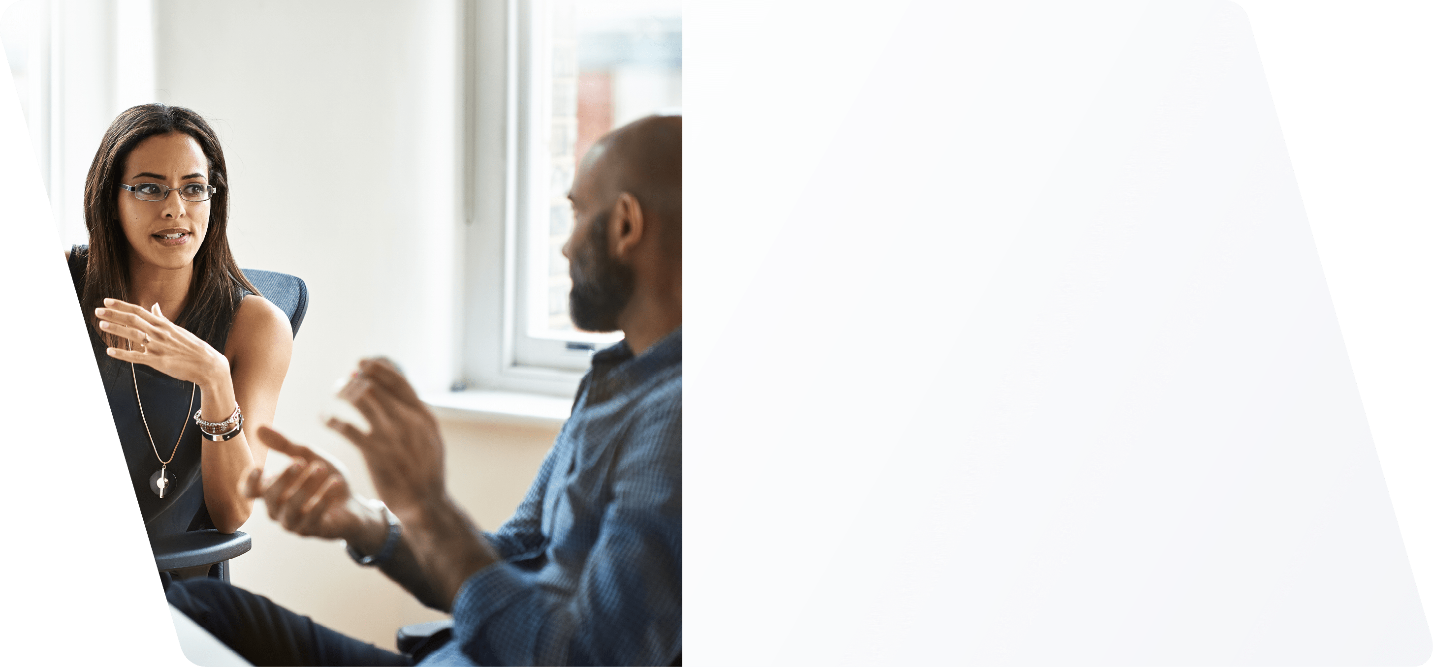 Woman and man talking in modern office.